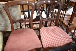 A pair of Victorian mahogany balloon back dining chairs, with moulded rails and serpentine fronted