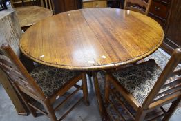 A nice quality oak reproduction pedestal dining table (two part top currently loose) , having turned