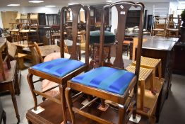 A pair of early 20th Century mahogany bedroom chairs having shaped legs and later blue upholstered