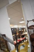 A vintage full length or width wall mirror, having smoked glass, approx. 213 x 50cm