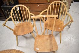 Three vintage Ercol chairs, all in the desirable light blonde stain, comprising two hoop and stick