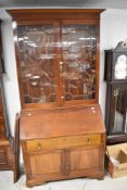 A 19th Century and later mahogany composite bureau bookcase having astral glazed section over drop