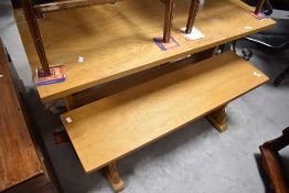 A traditional golden oak kitchen table and two similar benches, table approx. 115 x 62cm, some light
