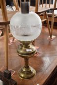 A traditional oil lamp having smoke glass chimney spherical part etched shade