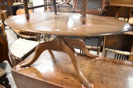 An Ercol or similar oval top coffee table in mid stain