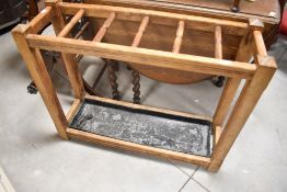 A late Victorian stained frame stick stand with matched metal drip tray, width approx. 91cm