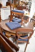A set of four Victorian balloon back dining chairs having turned legs, plus two extra seat pads