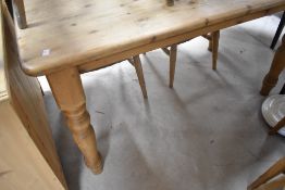 A traditional pine kitchen table of rectangular table on turned legs, approx. 137 x 76cm