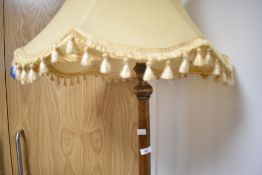 A traditional mahogany standard lamp, having shade