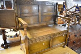 An early 20th Century oak monks bench, width approx. 100cm