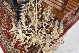 A modern ceiling light fitting, chandelier, with faux candles and foliate design