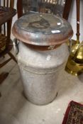 A vintage milk churn , with lid