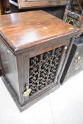 A modern sheesham style side cabinet having cast grille to front, dimensions approx. Height 76 width