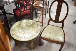 An Edwardian mahogany oval back bedroom chair and Egyptian themed brass topped coffee table
