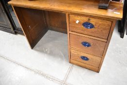 An early 20th Century golden oak office desk of nice proportions having three side drawers,