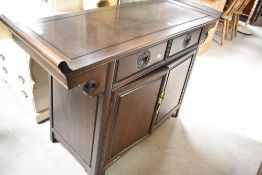 A Chinese pagoda style hardwood side cabinet , comprising two drawers over double cupboard,