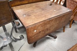 A 19th Century mahogany breakfast table having short drop flaps, frieze drawer and quadruple legs,