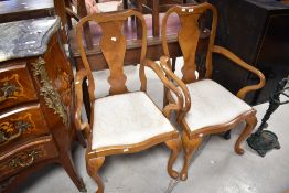 A pair of early 20th Century walnut carver chairs having vase backs and Queen Anne style legs