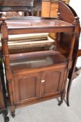 A Victorian mahogany buffet having two upper shelves over cupboard base , on turned frame,