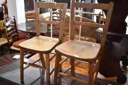A pair of traditional solid seat child's chairs, having rail backs, seat height approx. 35cm,