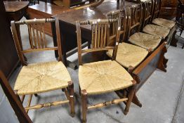 A set of six rush seated rail back kitchen dining chairs, some having been refurbished