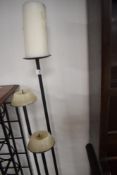 A wrought iron three branch candle stand, max height approx. 122cm to candle base