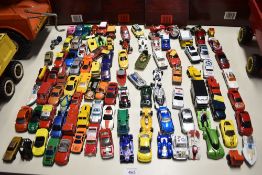 A large collection of unboxed toy vehicles in various scales, primarily 1:64. The assortment