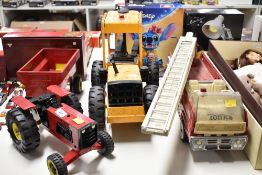 A group of three vintage Tonka toys constructed from pressed steel with plastic accents. The