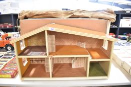 A vintage two-storey open-fronted dollhouse manufactured by Lundby of Sweden, presented in 1:16