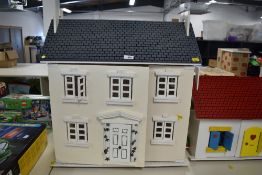 A pair of contemporary wooden dollhouses of matching style and construction, attributed to Hooga.
