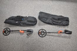 A pair of Vibra-Tector 750 folding pulse induction metal detectors, constructed with black