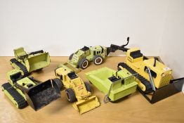 A collection of six vintage Tonka construction vehicles and components, primarily constructed from