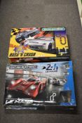 This lot comprises a pair of boxed 1:32 scale electric slot car racing sets manufactured by
