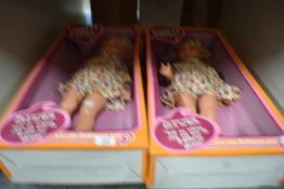 A pair of Pedigree Chatty Cathy talking dolls, appearing to be later collectible re-issues of the