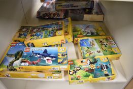 A collection of modern toys and construction sets in original retail packaging, primarily comprising