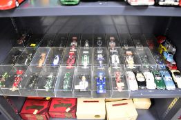 A collection of approximately forty die-cast model vehicles, primarily in 1:43 scale. The collection