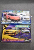 Two boxed 1:32 scale electric slot car racing sets manufactured by Scalextric. The first set is