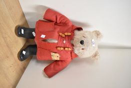 This is a vintage plush teddy bear of the character Paddington, manufactured by Gabrielle Designs
