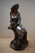 A large Art Deco style patinated metal figurine, similar to work of Alice Heath, depicting a lady