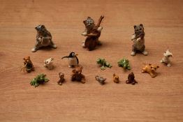 An assortment of small porcelain animal studies including penguin, cats and frogs.