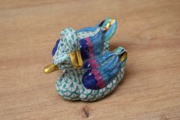 A 19th century Herend porcelain fishnet pattern duck group, having blue mark stamped to base,