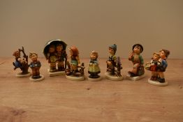 A group of eight Goebel pottery figures/figurines to include 'Surprise' model number 94, 'Just