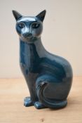 A 20th century Poole pottery blue glazed Siamese cat study, marking to base, measures 29cm tall.
