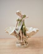 A late 19th century Royal Dux porcelain centrepiece, modelled as a classically dressed maiden