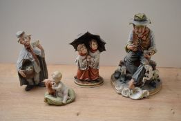 A group of four Capodimonte and similar porcelain figures/figurines to include 'Tramp with dog on