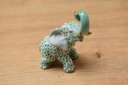 A 19th century Herend porcelain fishnet pattern elephant study, having blue mark stamped to base,