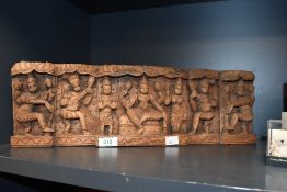 A late 20th-century Balinese-style hand carved wooden wall decoration, featuring a selection of