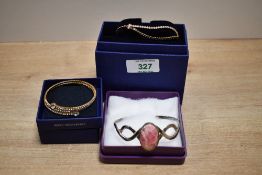 Two boxed Swarovski Crystal set bracelets, along with a silver rhodochrosite set cuff bracelet,