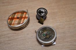 Three late 19th to early 20th-century sewing tape measures, including a Louis Wain cat-style example