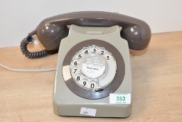 A vintage GPO 746-style rotary dial telephone, featuring a warm brown handset and a grey body,